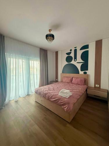 a bedroom with a bed and a chandelier at Vila Lux Braila in Brăila