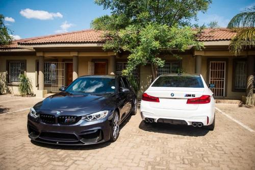 two cars parked in front of a house at Home Very Close To CBD in Gaborone