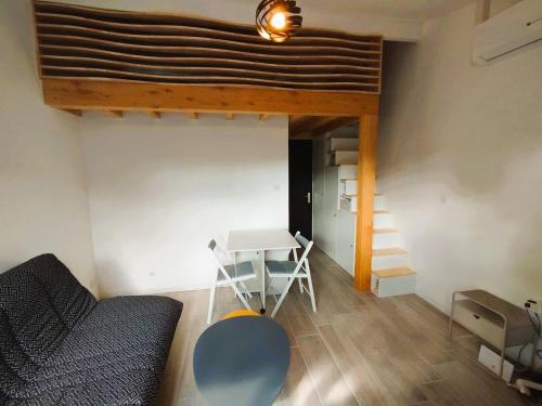 a room with a loft bed and a desk and a table at Logement à deux pas du lac Carcans Maubuisson in Carcans