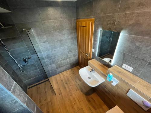 a bathroom with a shower and a toilet and a sink at Hotel Terasa in Frýdek-Místek