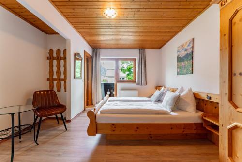 a bedroom with a bed with a wooden ceiling at Ferienhaus Pichl in Bruck an der Großglocknerstraße