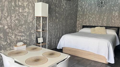 a bedroom with a bed and two tables in it at Estudio Loft in La Pineda