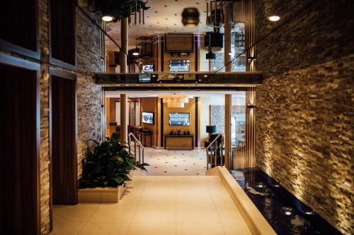 a hallway in a building with a brick wall at Hotel Zürserhof in Zürs am Arlberg
