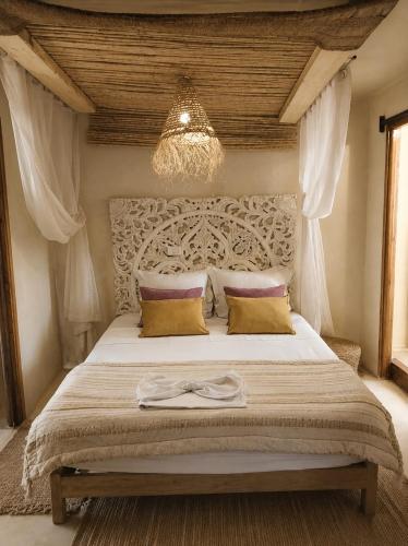a bedroom with a large bed with a large headboard at Al Madina, traditional Riad in Bizerte