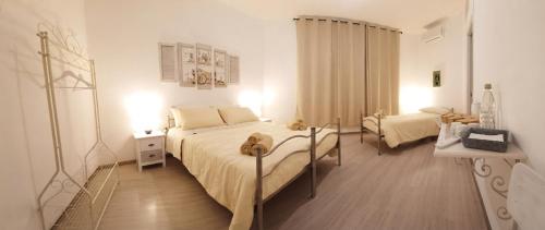 a bedroom with a bed with a dog laying on it at S'apposentu 'e Santa Ruche in Oniferi