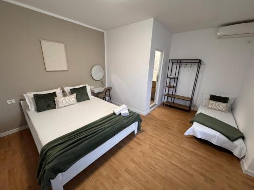 a bedroom with a large bed and a mirror at Vila Happy House in Costinesti