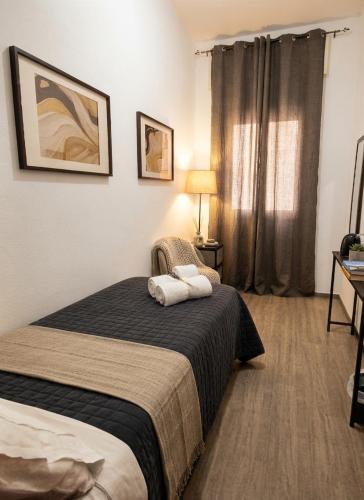 a hotel room with a bed with two towels on it at S'apposentu 'e Santa Ruche in Oniferi