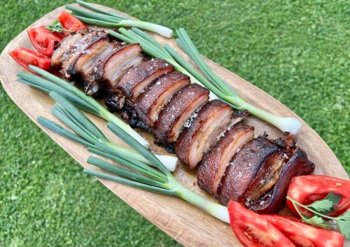 a plate of food with meat and vegetables on a table at Etno Selo Grabovicka Jutra in Cetinje