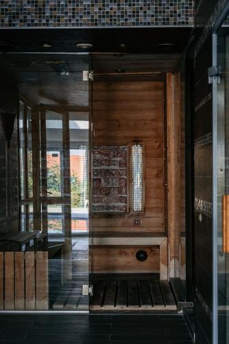 an entrance to a building with a wooden door at Tihany Panoráma Apartman in Tihany
