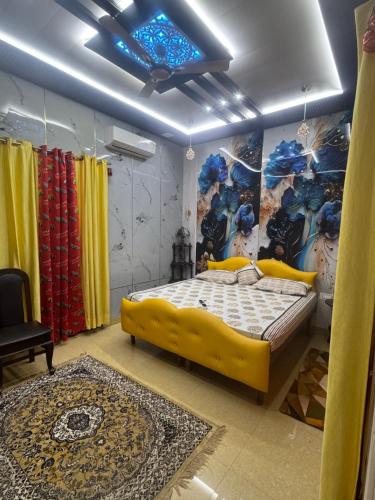 a bedroom with a large yellow bed in a room at Homestay, hotel at Pathankot in Pathānkot