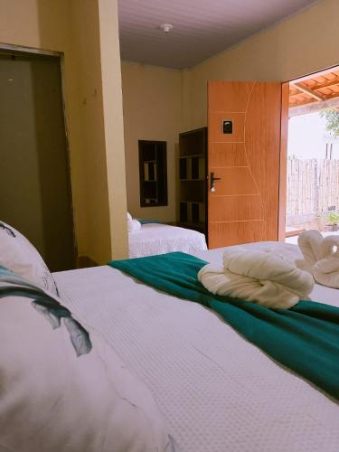 a bedroom with a bed with towels on it at Bom Viver Pousada-Viçosa do Ceará -CE in Viçosa do Ceará