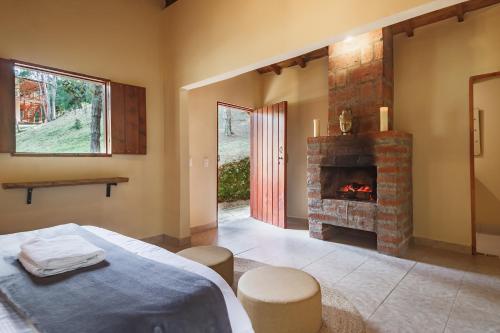 a bedroom with a bed and a fireplace at Olimpo Interior in Santa Elena