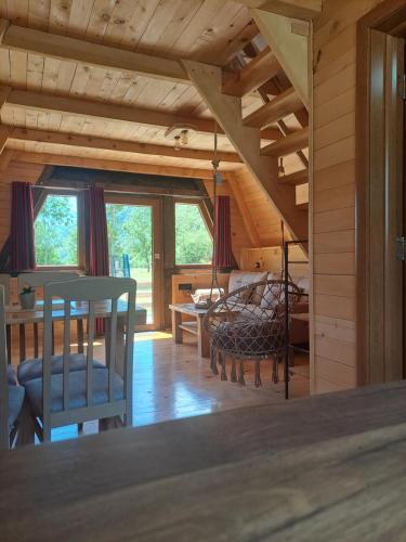 a kitchen and dining room with a table and chairs at Wooden cottages KONAK in Šavnik