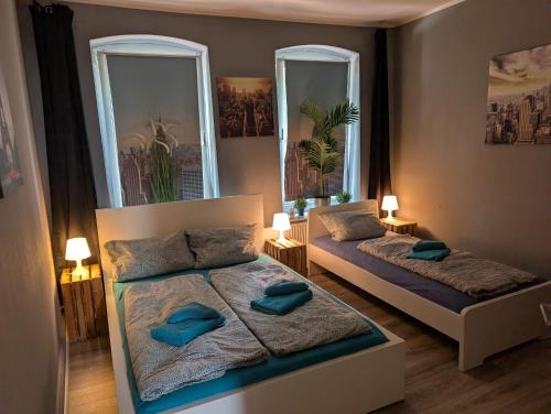 a bedroom with two beds and two mirrors at FördeNest in Flensburg