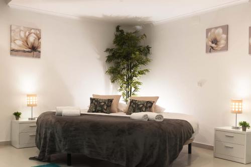a white bedroom with a large bed with pillows at West Side Guesthouse in Peniche