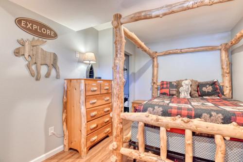 a bedroom with a wooden bed and a dresser at Fox Den Cozy Mountain Apt In GMF in Green Mountain Falls