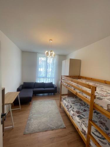 a room with two bunk beds and a couch at Leni Apartment in Patza-Kuqani
