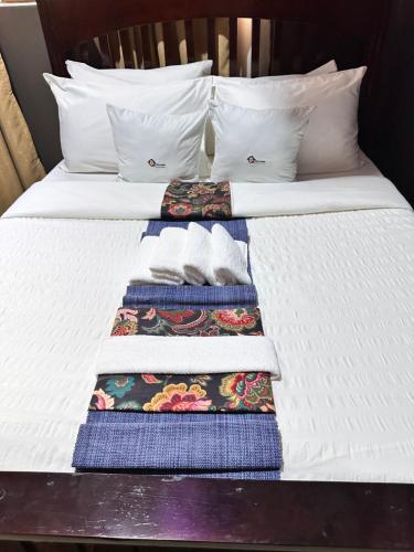 a bed with two towels and two pillows on it at Ekinot homes in Lira