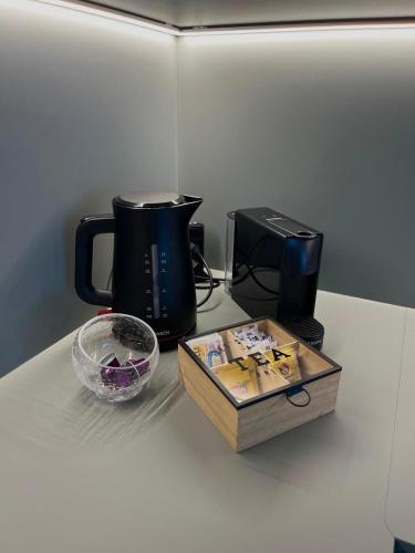 a counter with a coffee pot and a box on it at ALandGIO Smart Stay in Cavallino-Treporti