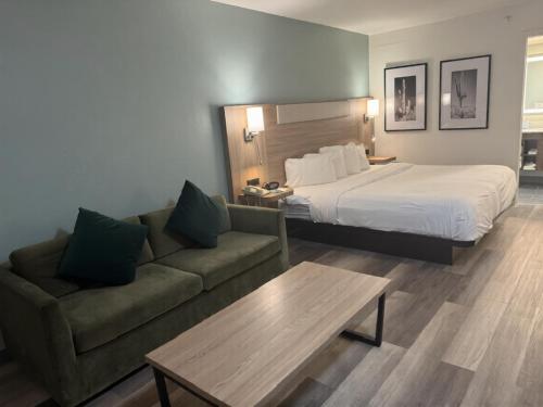 a hotel room with a bed and a couch at Quality Inn Casa Grande I-10 in Casa Grande