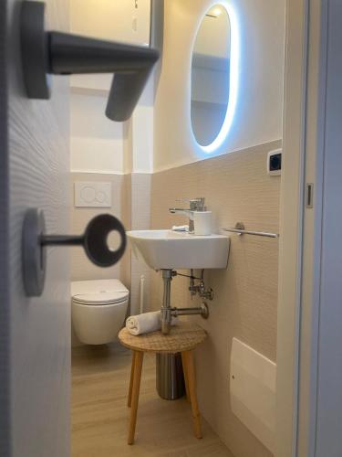 a bathroom with a sink and a toilet at Antigua 22 in Monopoli