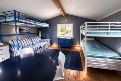 a room with a table and bunk beds at Turifoss Camping Cabin 2 in Svedjan
