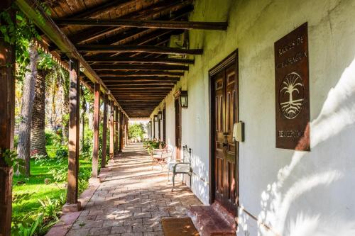 an empty hallway of an old building with a bench at Hotel Boutique Raíces de Colchagua in Santa Cruz