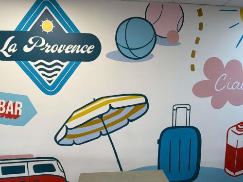 a wall mural of luggage and umbrellas at ibis budget Marseille Aeroport Provence in Marignane