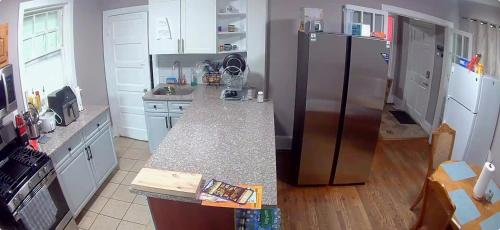 a kitchen with a stainless steel refrigerator and white cabinets at Casa Tabacon CR USA in Trenton