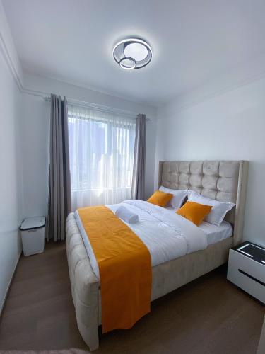 a bedroom with a large bed and a window at Meteor gardens in Nairobi