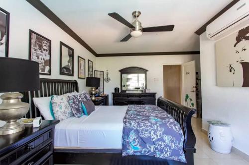 a bedroom with a bed and a ceiling fan at Hidden Gem Classic Room - by ZenBreak in Christ Church