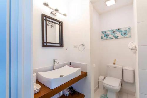 a white bathroom with a sink and a toilet at Hidden Gem Classic Room - by ZenBreak in Christ Church