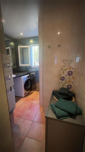a bathroom with a sink and a counter with towels at Maison Grebert in Gouffern en Auge