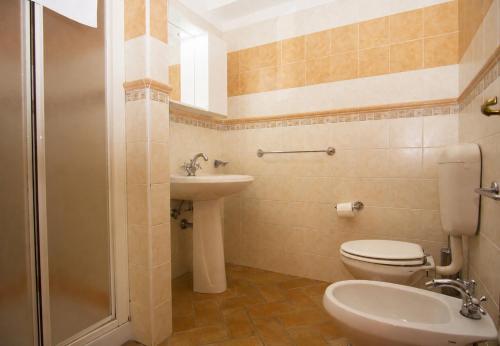 a bathroom with a toilet and a sink and a shower at Residence Baia Infreschi in Marina di Camerota
