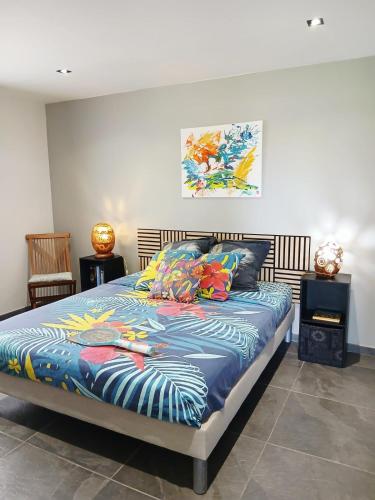 a bedroom with a bed with colorful pillows at BLUE DREAM SPA in Les Trois-Îlets