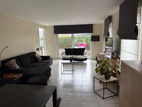 a living room with a couch and a table at Owla-Stay in Heusden - Zolder