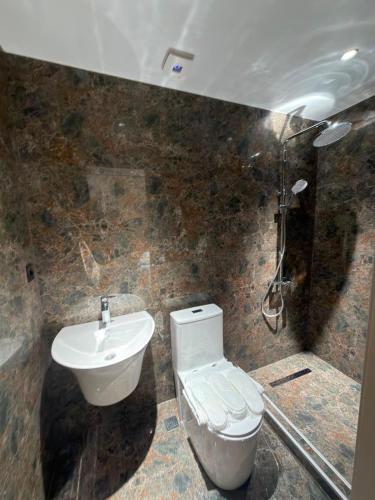 a bathroom with a toilet and a sink at Our House in Kobuleti