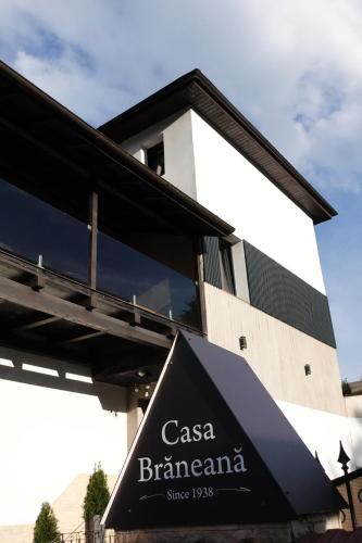 a building with a sign in front of it at Casa Braneana in Bran