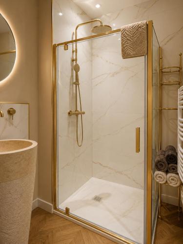a shower with a glass door in a bathroom at Appartement Collection Sea View in Saint-Valéry-sur-Somme