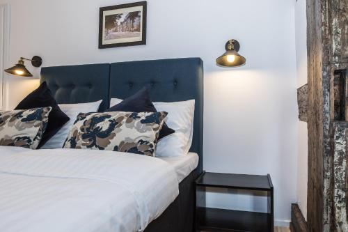 a bedroom with a bed with a black headboard at Heritage House in Klaipėda