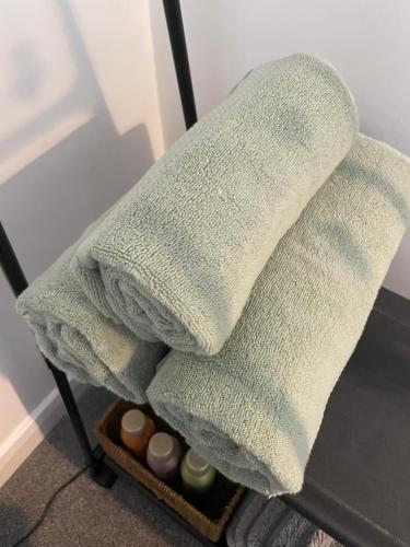 two towels sitting on top of a chair at Rushes View Homestay in Market Harborough