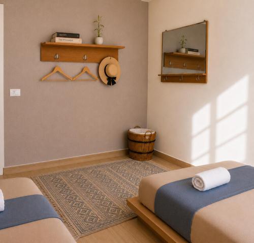 a bedroom with two beds and a mirror at Champollion Hostel in Cairo