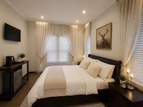 a bedroom with a large bed and a window at ACRE on Albatros in Gqeberha
