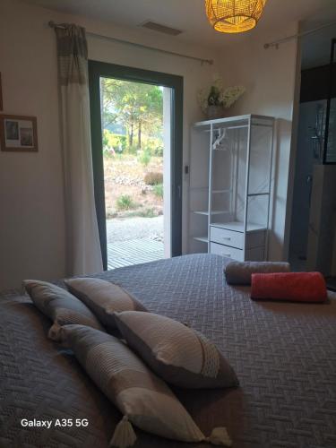 a bedroom with a bed with pillows on it at Villa MOUREZEVA in Mourèze