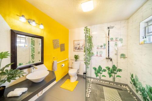 a bathroom with a shower and a toilet and a sink at Hidden Gem The Serenity - by ZenBreak in Christ Church