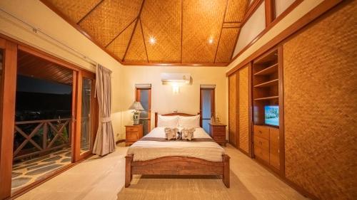 a bedroom with a bed with two animals on it at Orchid House Pattaya, Totally Private Pool in Pattaya South