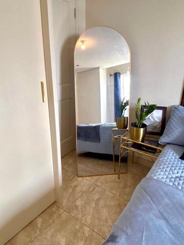 a bedroom with a bed and a mirror at Cazuria - by ZenBreak in Saint George