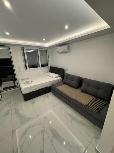 a living room with a bed and a couch at Premium Studio Family in Paralia Katerinis