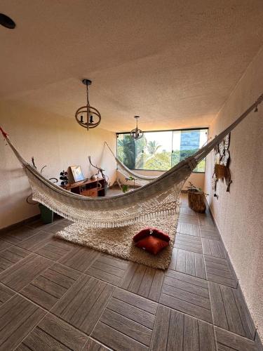 a hammock in the middle of a room at Hotel Sinhá in Tianguá