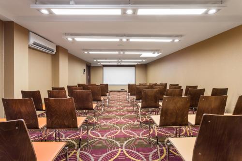 an empty room with chairs and a projection screen at Hotel DeSilva Premium Poznań in Poznań